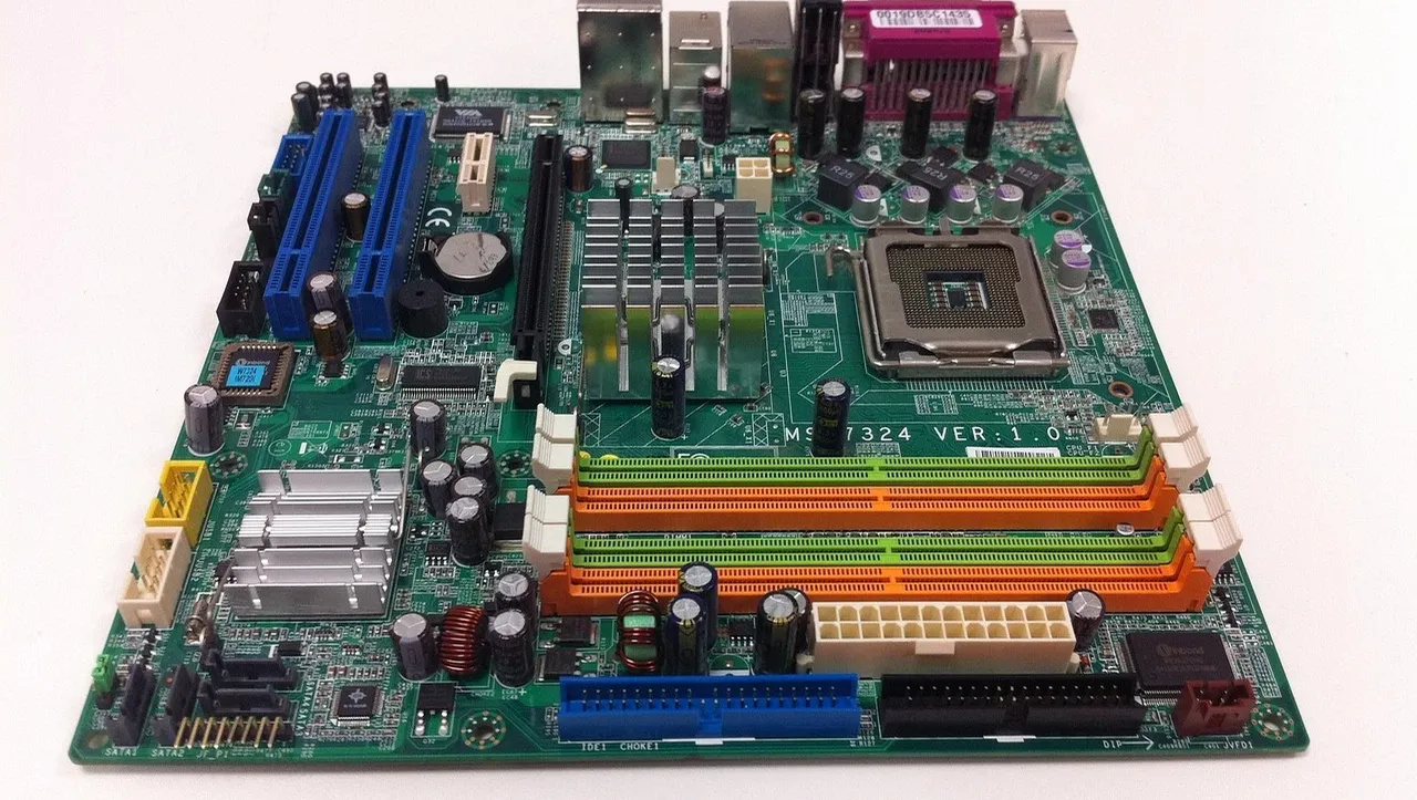 Close-up view of a complex printed circuit board with various electronic elements and lighting, conveying the intricacy of modern electronics.